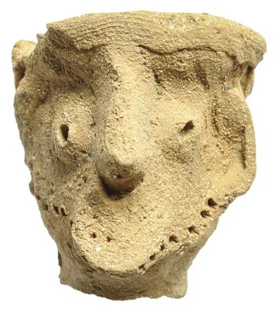 This clay male figurine was found at the Tel Moẓa temple along with another male figurine and two horse artifacts. Dated to the late tenth or early ninth century BC, it has pronounced facial features and wears a headdress. Garfinkel describes it as similar to the Qeiyafa figurine, and believes it may be a Yahweh Idol, representing Yahweh or another male god. (Clara Amit / Israel Antiquities Authority)