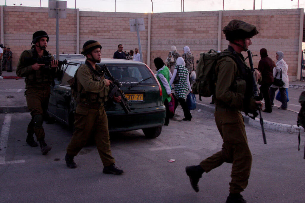 Israeli soldiers patrol the area outside the Qalandia checkpoint in the West Bank, 2009. (Photo: Issam Rimawi/APA Images)