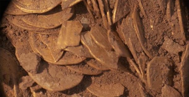 Part of the substantial gold coin hoard still in the ground. (Israel Antiquities Authority)