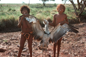 Proud Aboriginal boys holding a bush turkey