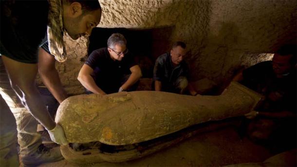 Egyptian Antiquities Minister Khaled Al-Anani, seen in the photo inspecting one of the coffins, announced the find of a collection of thirteen sealed and intact coffins dating back 2,500 years. (Egyptian Ministry of Tourism and Antiquities)