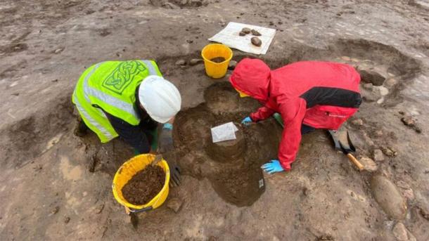 How the Bronze Age burial urn was found in the ground, upside down. (Fadó Archaeology)