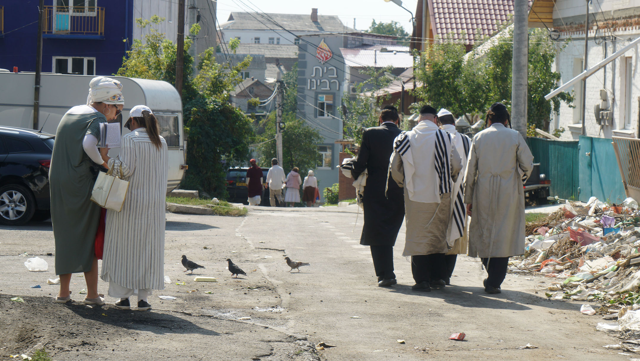 Jews walk down an alley leading to Pushkina Street in Uman, Ukraine on Sept. 8, 2017. (Cnaan Liphshiz)