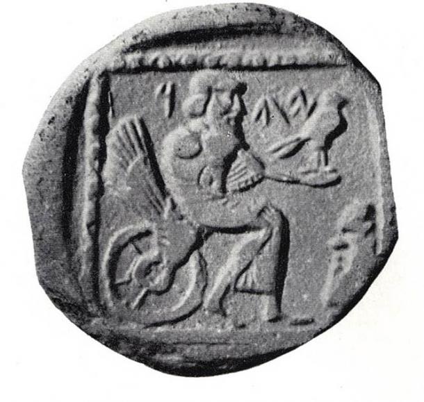 Phoenician drachm, 4th century BC, on exhibit in the British Museum. The coin shows a seated deity, labelled either "YHW" (Yahu) or "YHD" (Judea). (Public Domain)