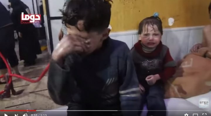 femicide Now soaked boy wipes water from his eyes. Baby on bed is soaked & shivering.