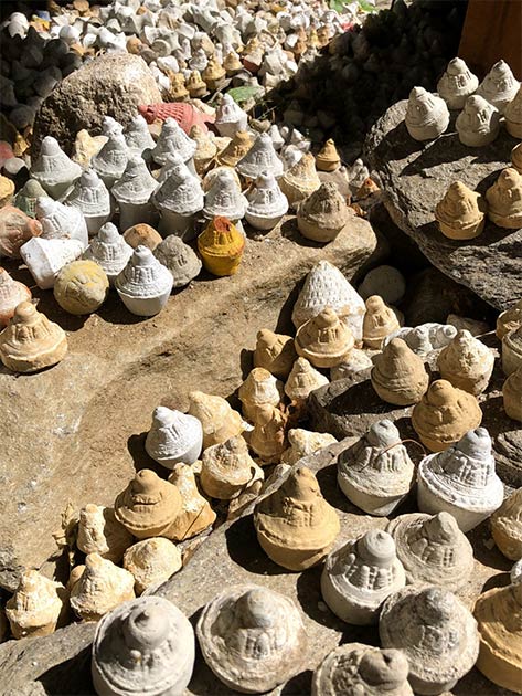 Tsha-tsha clay offerings left by Buddhist pilgrims at the Burning Lake. (YWL / Adobe Stock)