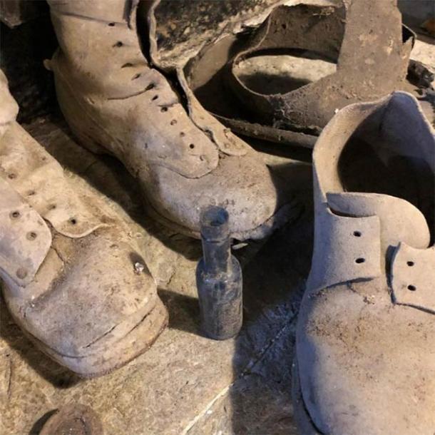 The shoes and witch bottle that traps witches and demons found under the staircase in the Welsh home. (Kerrie Jackson / Denbighshire County Council)