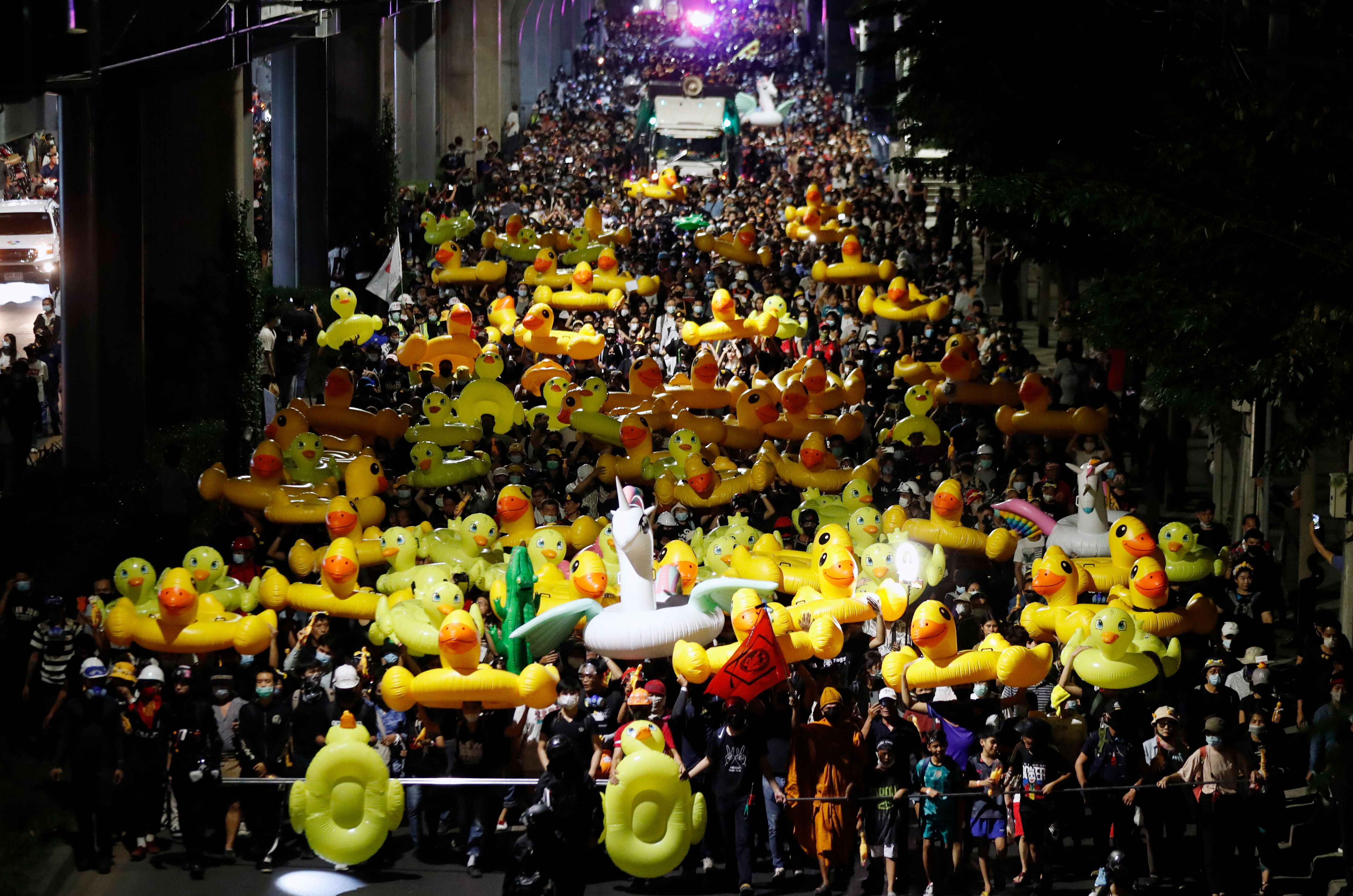 Protesters carry inflatable yellow ducks, which have become good-humored symbols of resistance during anti-government rallies