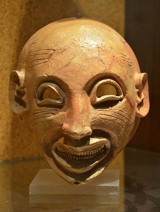 Mask showing a possible sardonic grin.