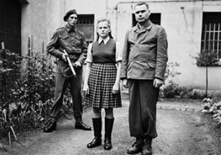 Irma Grese and Josef Kramer standing in the courtyard