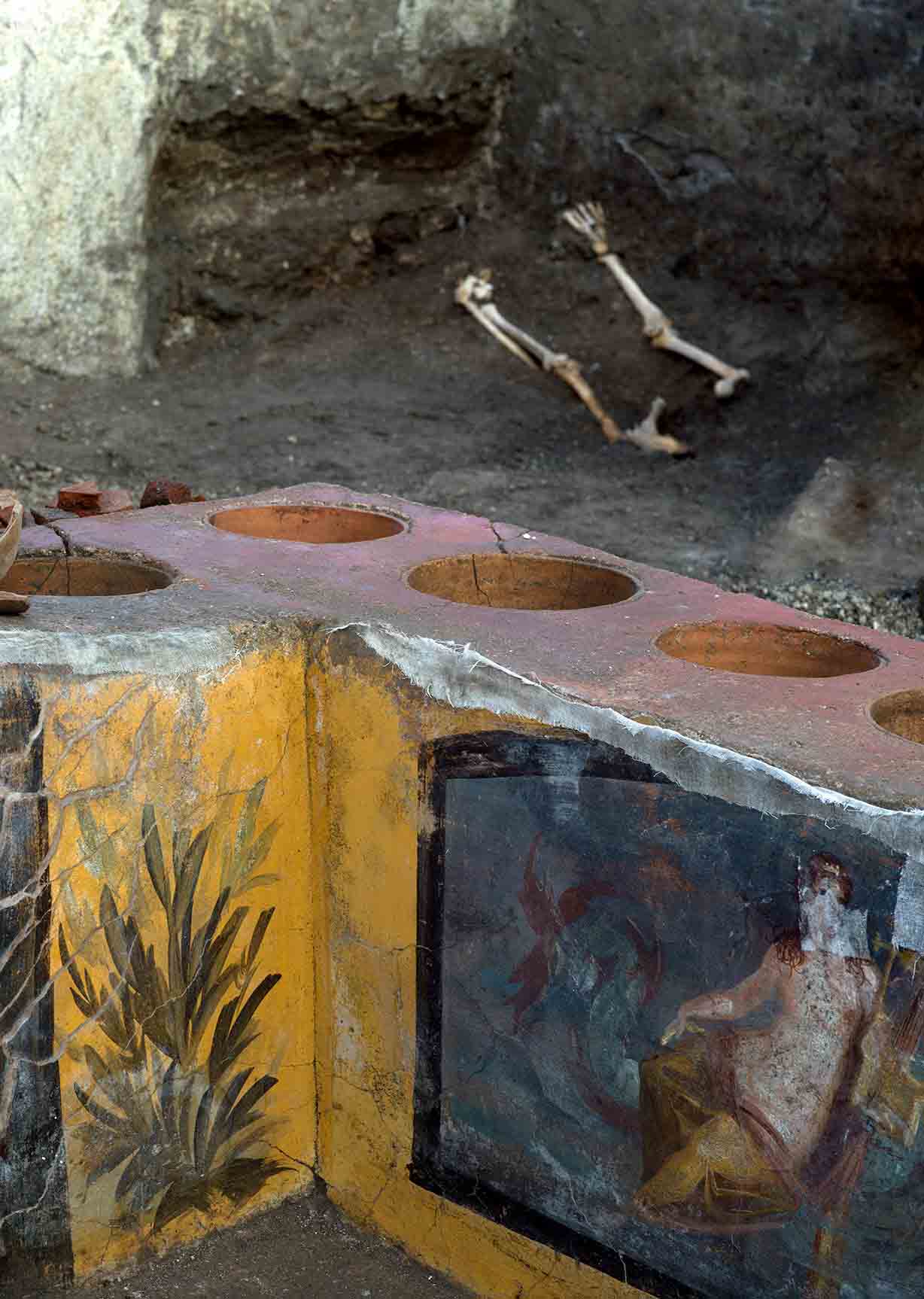 The remains of one of the individuals at the top of this image, who was discovered on a bed in the back of a room at the amazing Pompeii food stall found in March 2019 AD at the Regio V site. (Pompeii Archaeological Park)