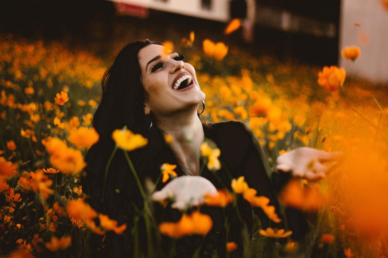 Image of a woman laughing and learning how to love herself more