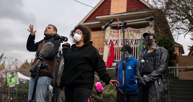 PORTLAND, OR - DECEMBER 09: Activists and the Kinney family speak to the press about the citys attempted eviction of residents from the Red House on Mississippi Ave on December 9, 2020 in Portland, Oregon. Police and protesters clashed during an attempted eviction Tuesday, leading protesters to establish a barricade around the Red House. (Photo by Nathan Howard/Getty Images)