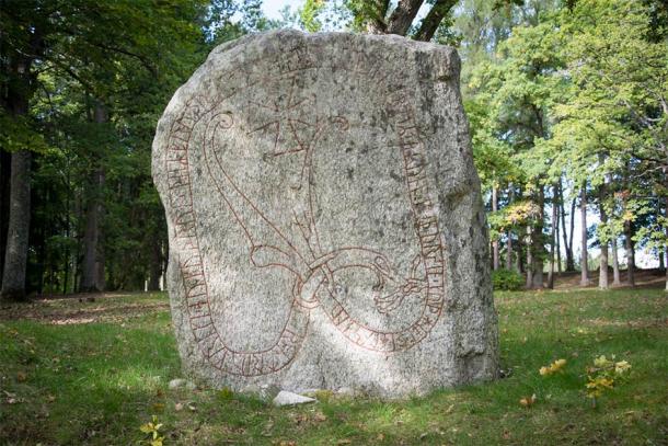 One of the stones displaying runes, the cross and pagan artwork (Mats / Adobe Stock)