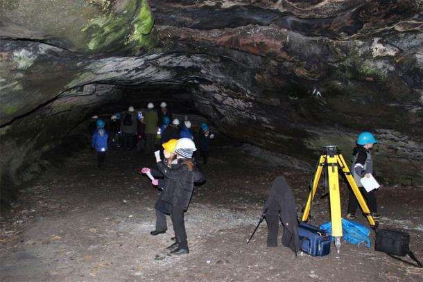 Group of students on a visit to Jonathan’s Cave, the most iconic of the Wemyss Caves due to it being home to some of the best preserved Pictish carvings. (The Scape Trust)