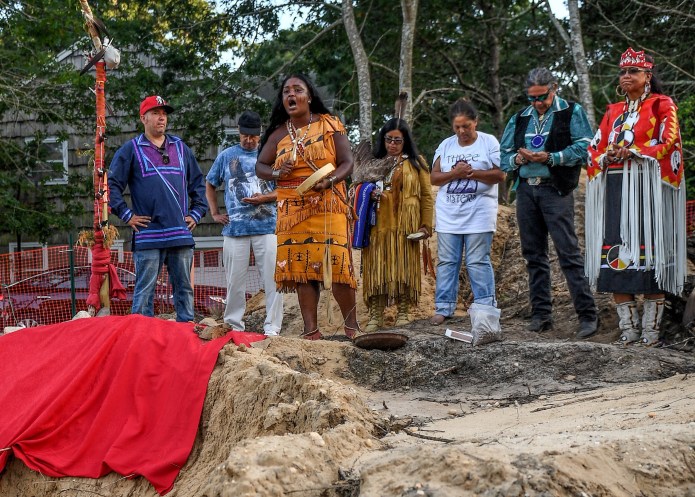 Shinnecock tribe members hold a prayer service on a site where human remains, likely belonging to the Shinnecock Nation, were unearthed.