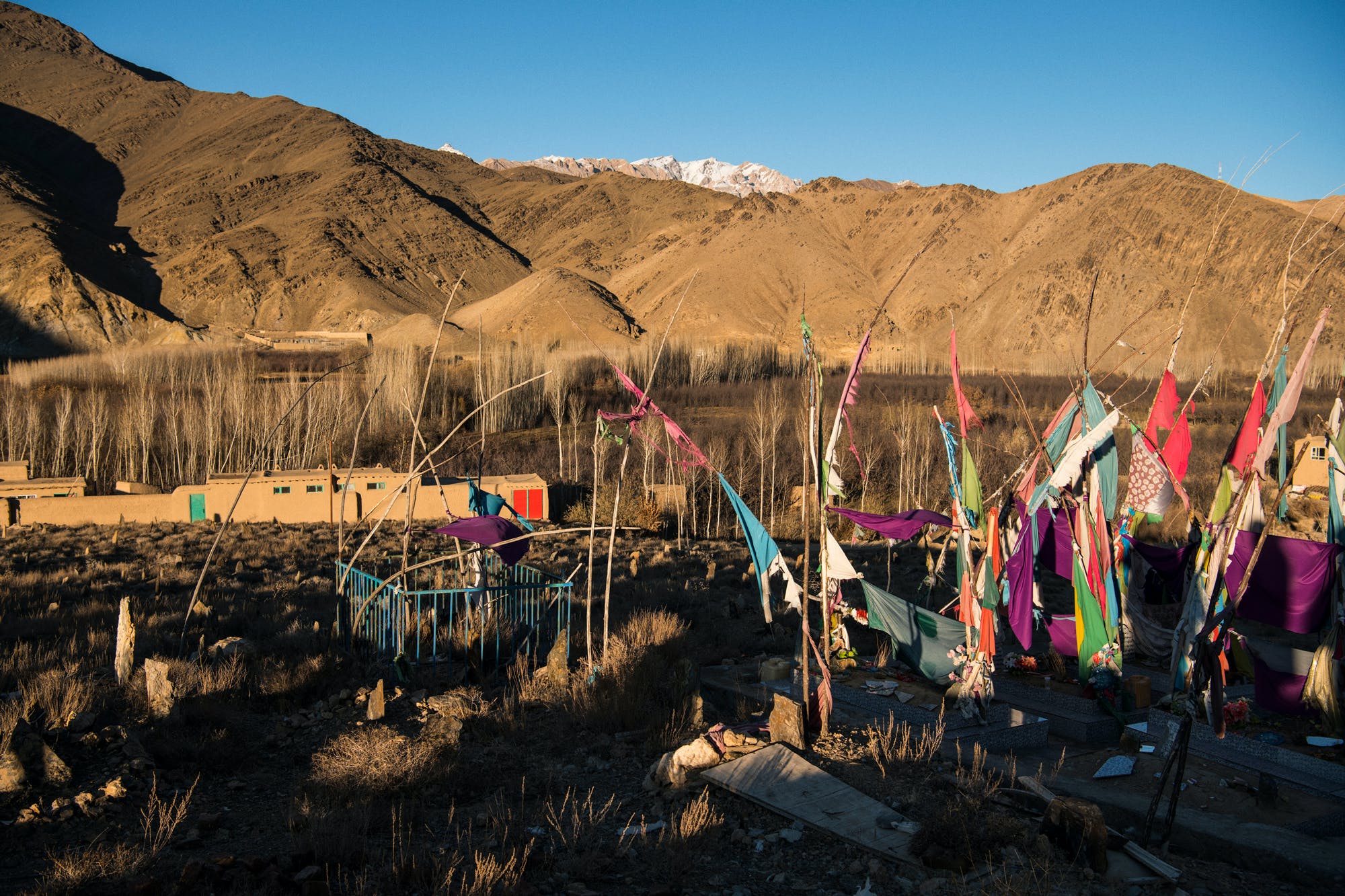 Homemade flags mark the graves of a mother and three children, ages 6, 8, and 15, who were killed in a 01 night raid in the village of Sher Toghi, Daymirdad District, on the night of March 2 and the morning of March 3, 2019. The 15-year-old was shot when he ran outside to look for help after a bomb hit the family home. Relatives found the bodies of the mother and daughters beneath the ruins of their house the next morning. It isn’t known whether they succumbed to injuries from the air strikes or the freezing temperatures overnight.
