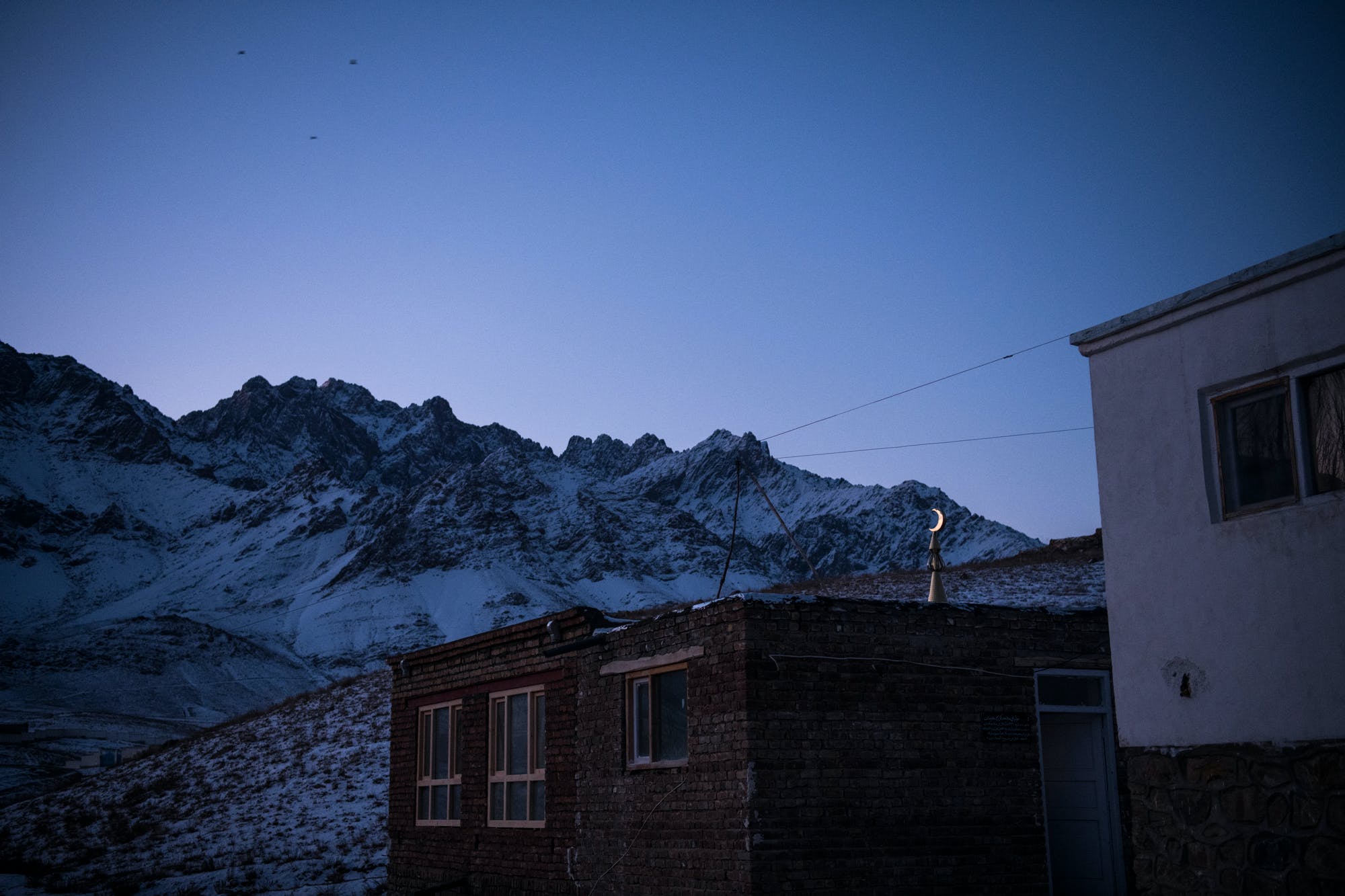 A crescent moon lit by the rising sun above a mosque in the village of Araban in Wardak’s Chak District. Mosques and Islamic schools, known as madrassas, were regularly targeted by the CIA-led 01 strike force unit throughout Wardak in late 2018 and 2019, killing 33 religious students, according to The Intercept’s investigation.