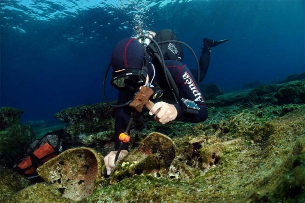 Archaeologist extracting an artifact from the Kasos Roman shipwreck – as carefully as is possible