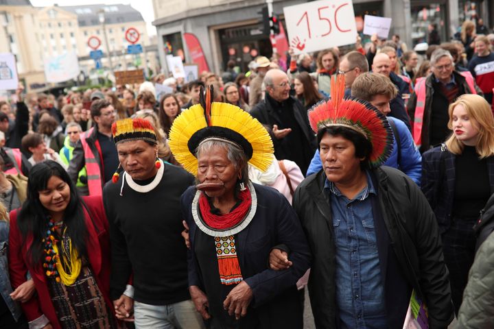 Chief Raoni Metuktire, center front, takes part in a climate march in Brussels on May 17, 2019. The activist has become a sym