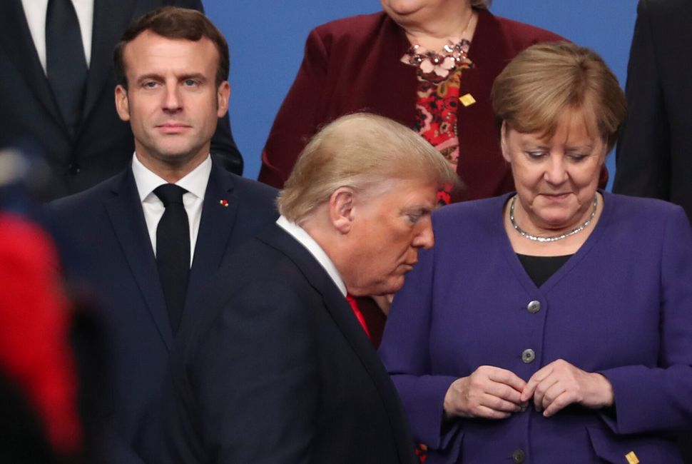 President Donald Trump in front of French President Emmanuel Macron (left) and German Chancellor Angela Merkel (right) prior 