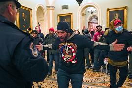 Trump supporters in front of U.S. Capitol Police in the hallway outside of the Senate chamber at the Capitol in Washington, USA. January 6, 2021