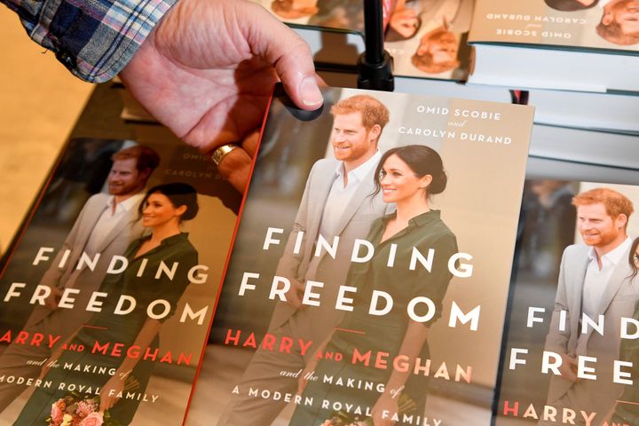 An employee holds a copy of 'Finding Freedom', an unofficial biography on Prince Harry and Meghan, the Duchess of Sussex, at 