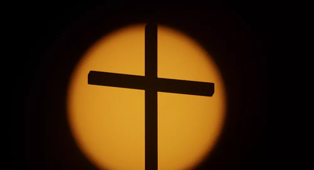 The cross on top of the First Baptist Church is silhouetted in front of the sun on Sunday, Aug. 20, 2017, in Simpsonville, S.C. South Carolina is gearing up for a total solar eclipse, which will cross the state diagonally during a phenomenon that will be seen across the country