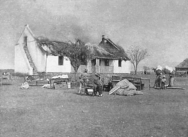 One British response to the Boer’s guerrilla war was a “scorched earth” policy to deny the guerrillas supplies and refuge. In this image Boer civilians watch their house as it burns. (Public domain)