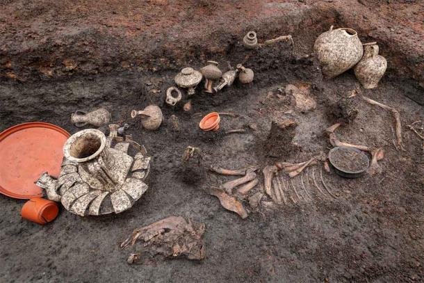 The Roman baby burial included an infant skeleton, surrounded by a pet dog, a pig, twenty terracotta vases and various food and meat offerings. (Denis Gliksman / INRAP)