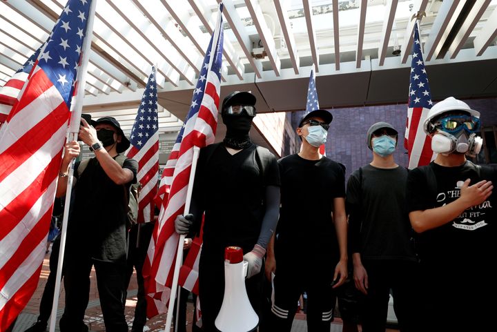 Anti-government protesters holding US flags during a rally at the University of Hong Kong on September 20, 2019.