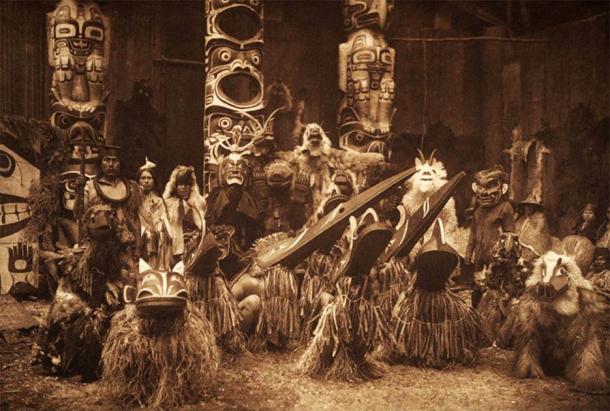 Masked Kwakiutl dancers during the winter ceremony in an iconic photo by the ethnographic photographer Edward Curtis. (Public domain)