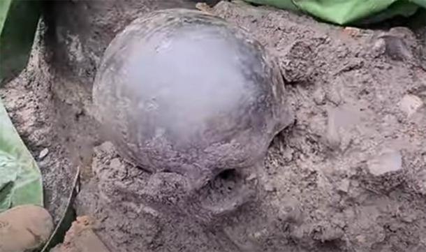 One of the skulls that was found at the site, blackened, presumably from the burning. (Bochnianin / You Tube)