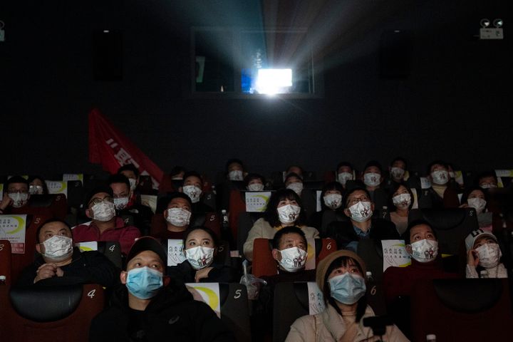 WUHAN, CHINA - JANUARY 23:（CHIHA OUT）Movie goers wear masks while attending the film "Days and Nights in Wuhan" in a cineplex