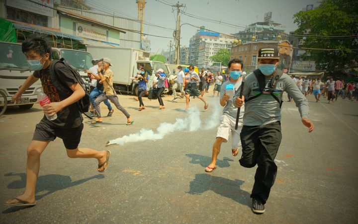 Security forces intervene in protesters as they gather to protest against the military coup in Yangon, Myanmar