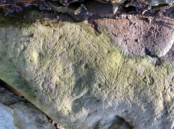 One of the decorated faces of a large stone found in Structure Ten, Ness of Brodgar, in 2013, that has the same markings as the new stone found at the Bay of Skaill. 