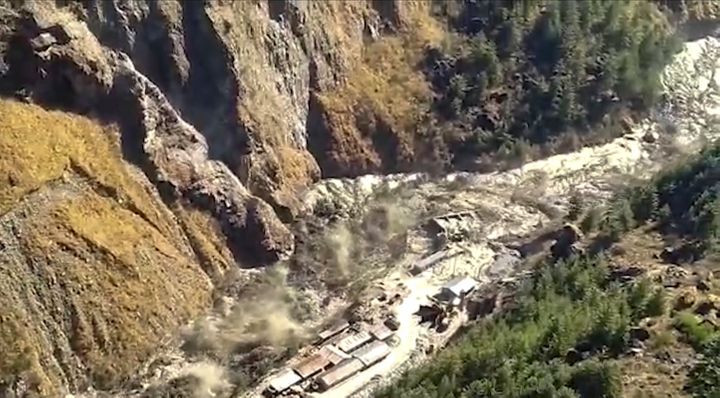 This frame grab from video provided by KK Productions shows a massive flood of water, mud and debris flowing at Chamoli Distr