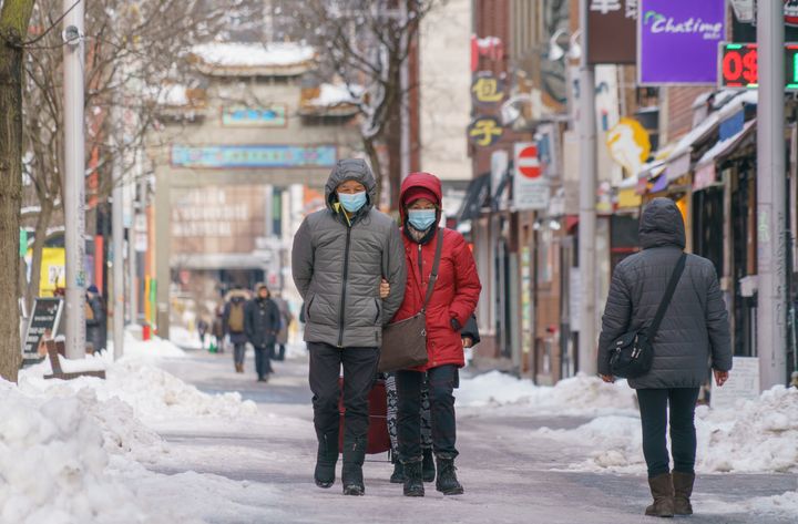 A couple walks in Chinatown during the COVID-19 pandemic in Montreal, on Monday, January 18, 2021.&nbsp;
