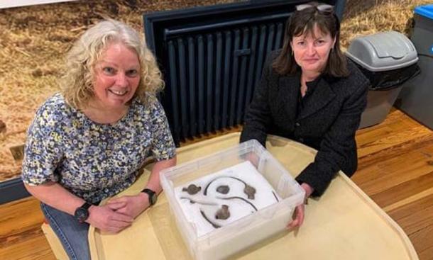 Posing with the impressive Viking hoard is Kath Giles, left, who found the hoard, and Allison Fox, curator for archaeology at Manx National Heritage. (Manx National Heritage Museum)