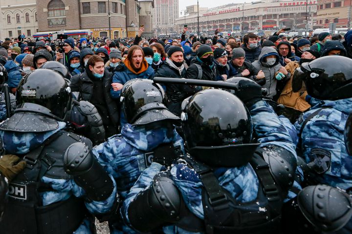 People clash with police during a protest against the jailing of opposition leader Alexei Navalny in Moscow, Russia, Sunday, 
