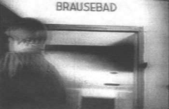 GI opens door of bogus 'gas chamber' at the Dachau; portion of a 1945 US propaganda film