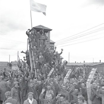 Dachau camp prisoners cheer their American liberators, April 29, 1945