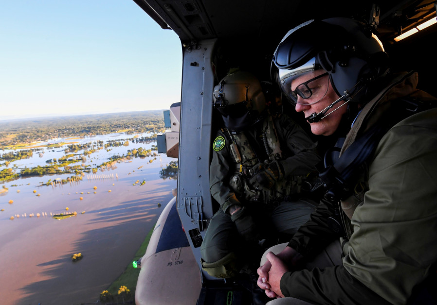 Australian Prime Minister Scott Morrison inspects damage created by floodwaters from a helicopter during a visit to flood affected areas in Sydney, Australia, March 24, 2021./ REUTERS