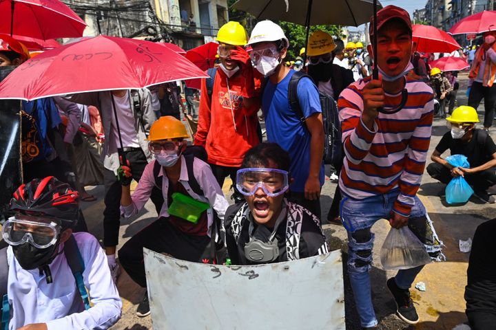 Protesters react during a demonstration against the military coup in Yangon on March 1, 2021.&nbsp;