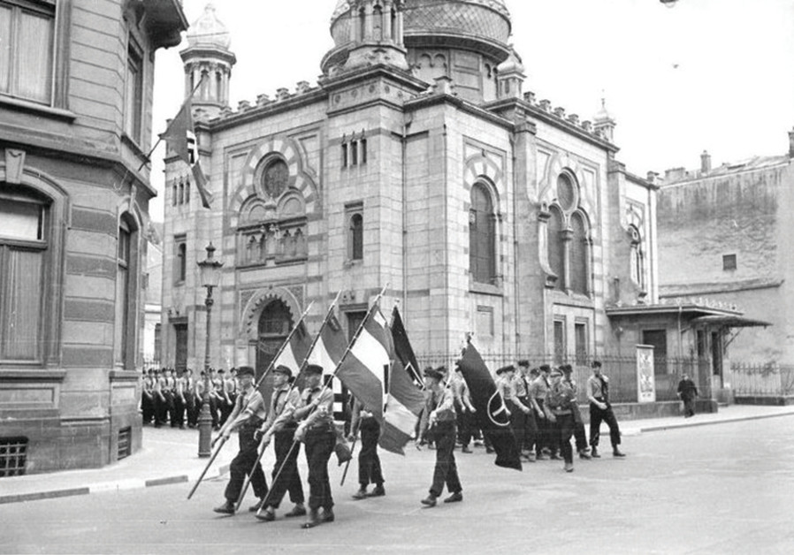 NAZIS MARCH past the synagogue in Luxembourg, 1941. It was destroyed in 1943. (JWH)
