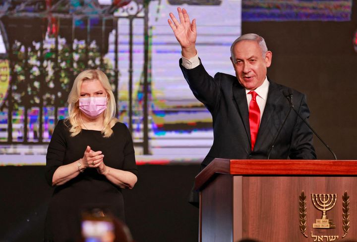 Israeli Prime Minister Benjamin Netanyahu, leader of the Likud party, appears with his wife Sara to address supporters at the