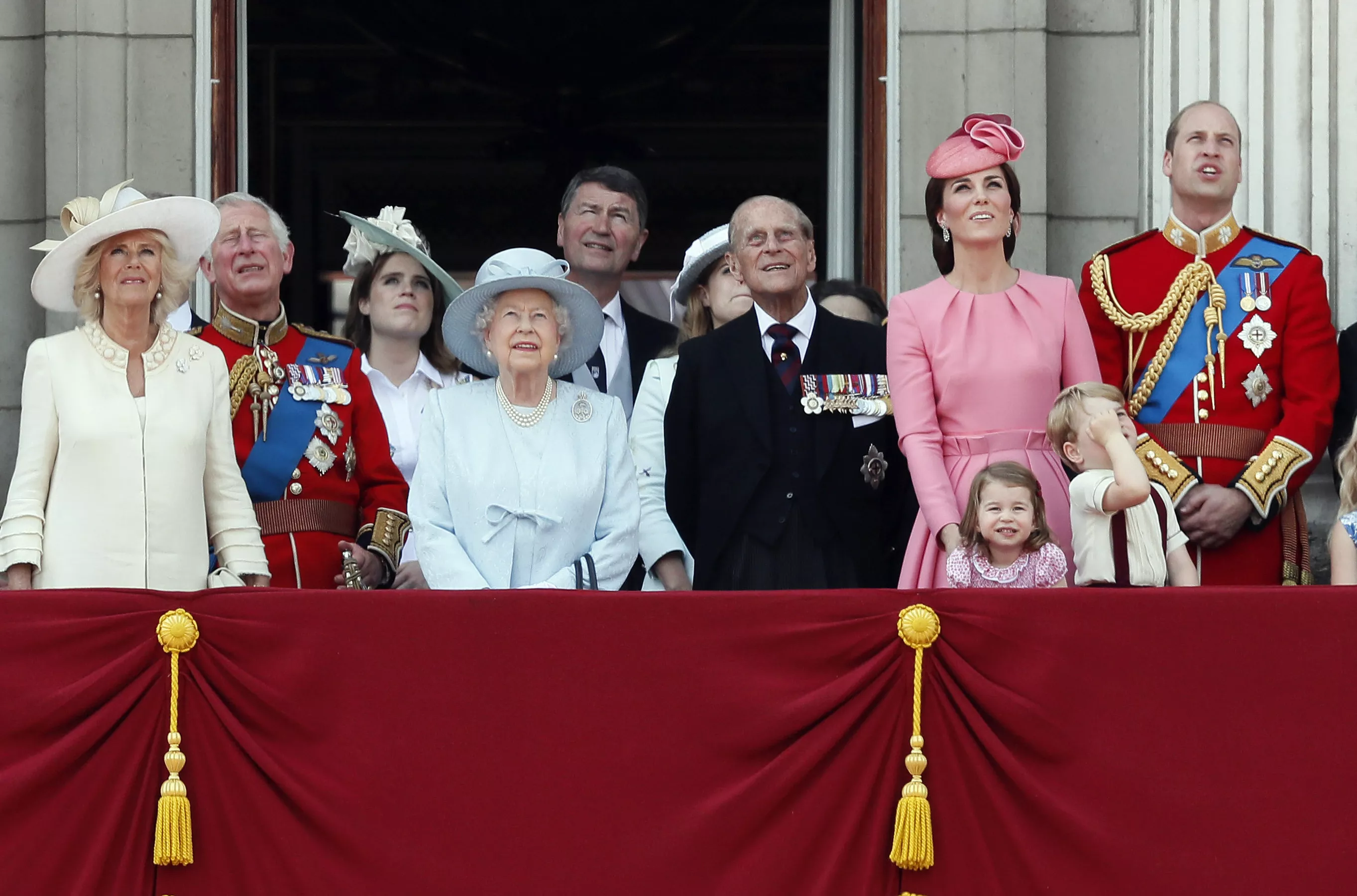Members of Britain's Royal family from left, Camilla, the Duchess of Cornwall, Prince Charles, Princess Eugenie, Queen Elizabeth II, background Timothy Laurence, Princess Beatrice, Prince Philip, Kate, the Duchess of Cambridge, Princess Charlotte, Prince George and Prince William watch a fly past as they appear on the balcony of Buckingham Palace, after attending the annual Trooping the Colour Ceremony in London, Saturday, June 17, 2017