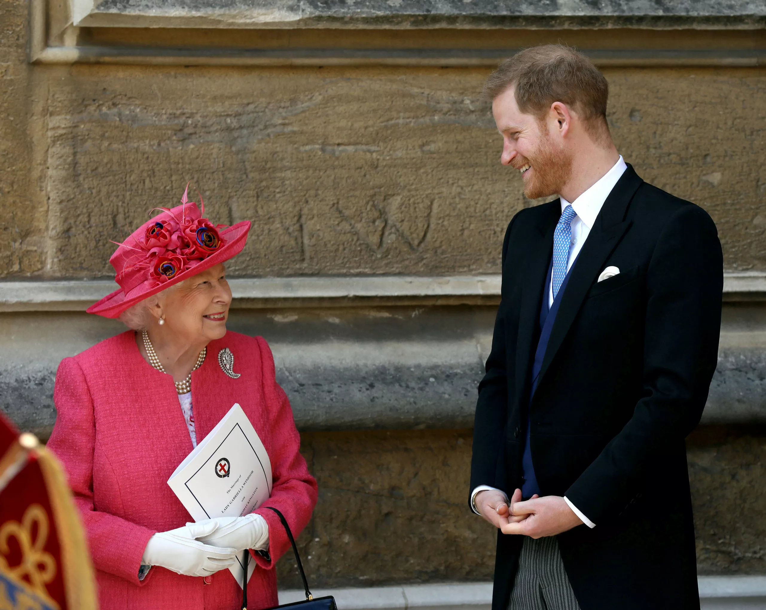  Queen Elizabeth II talks to Prince Harry as they leave after the wedding of Lady Gabriella Windsor and Thomas Kingston at St George's Chapel in Windsor Castle, near London, Britain May 18, 2019