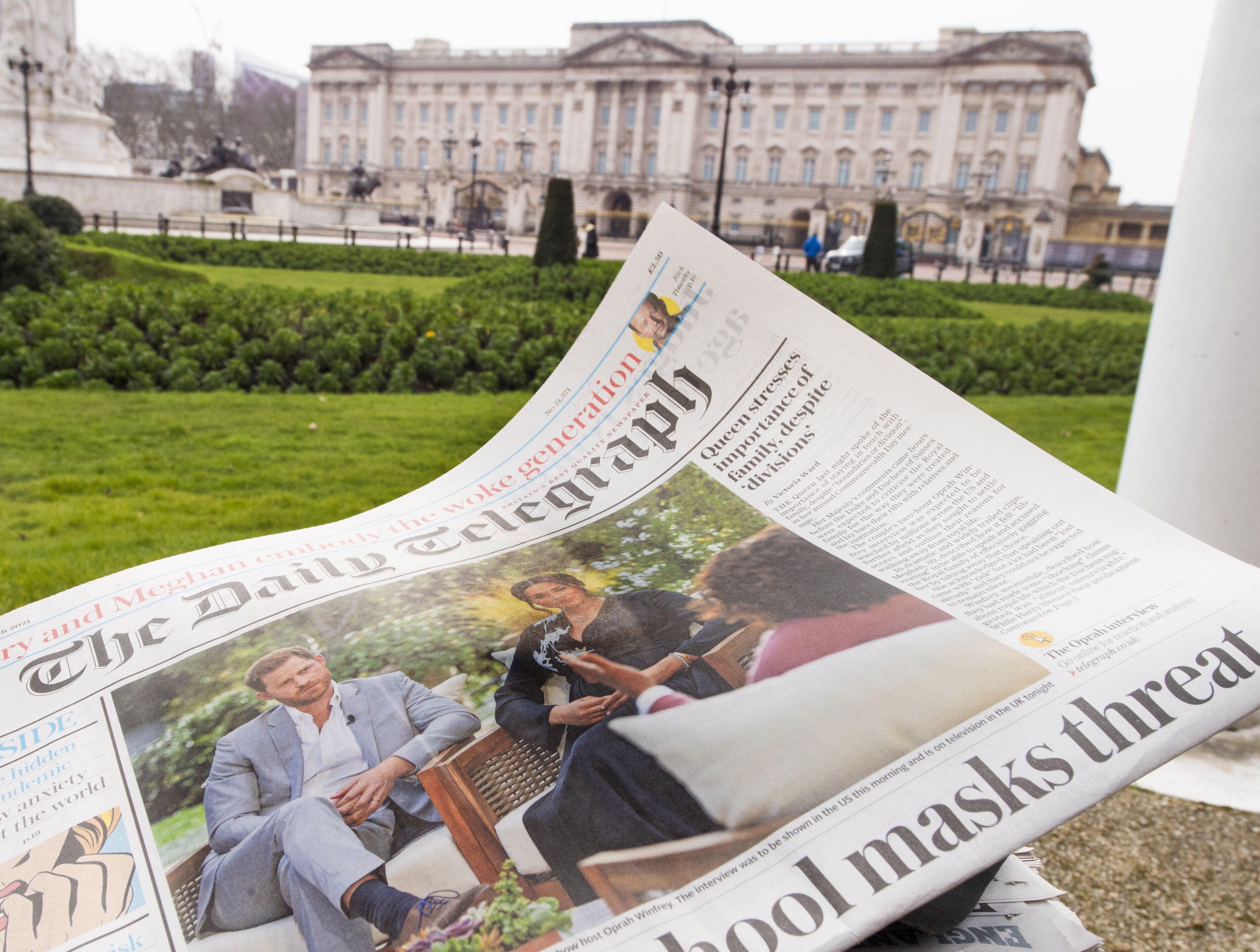 A British newspaper flutters in the wind outside Buckingham Palace in London the day after the Duke and Duchess of Sussex's i