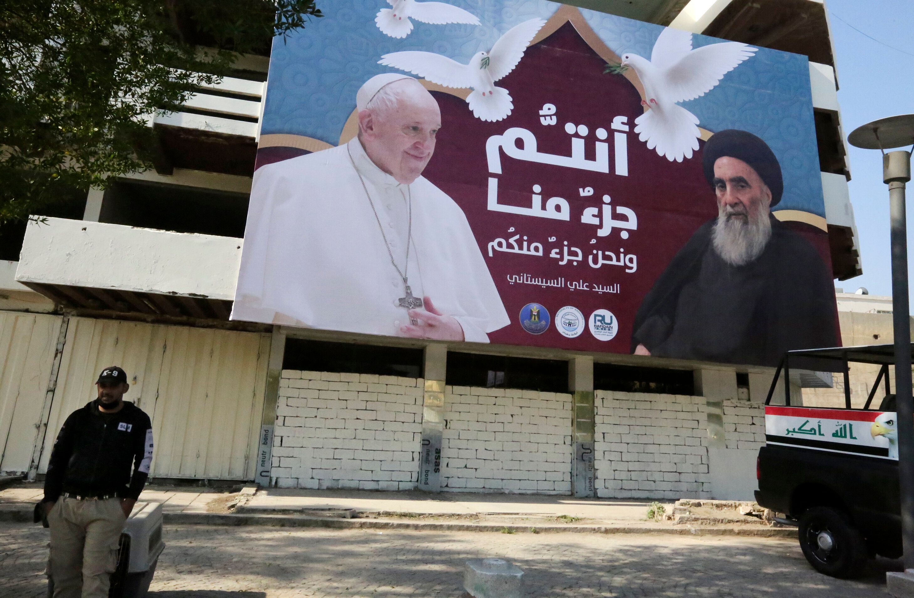 A giant billboard bears portraits of Pope Francis and Grand Ayatollah Ali Sistani in Baghdad on March 3, 2021 ahead of the fi